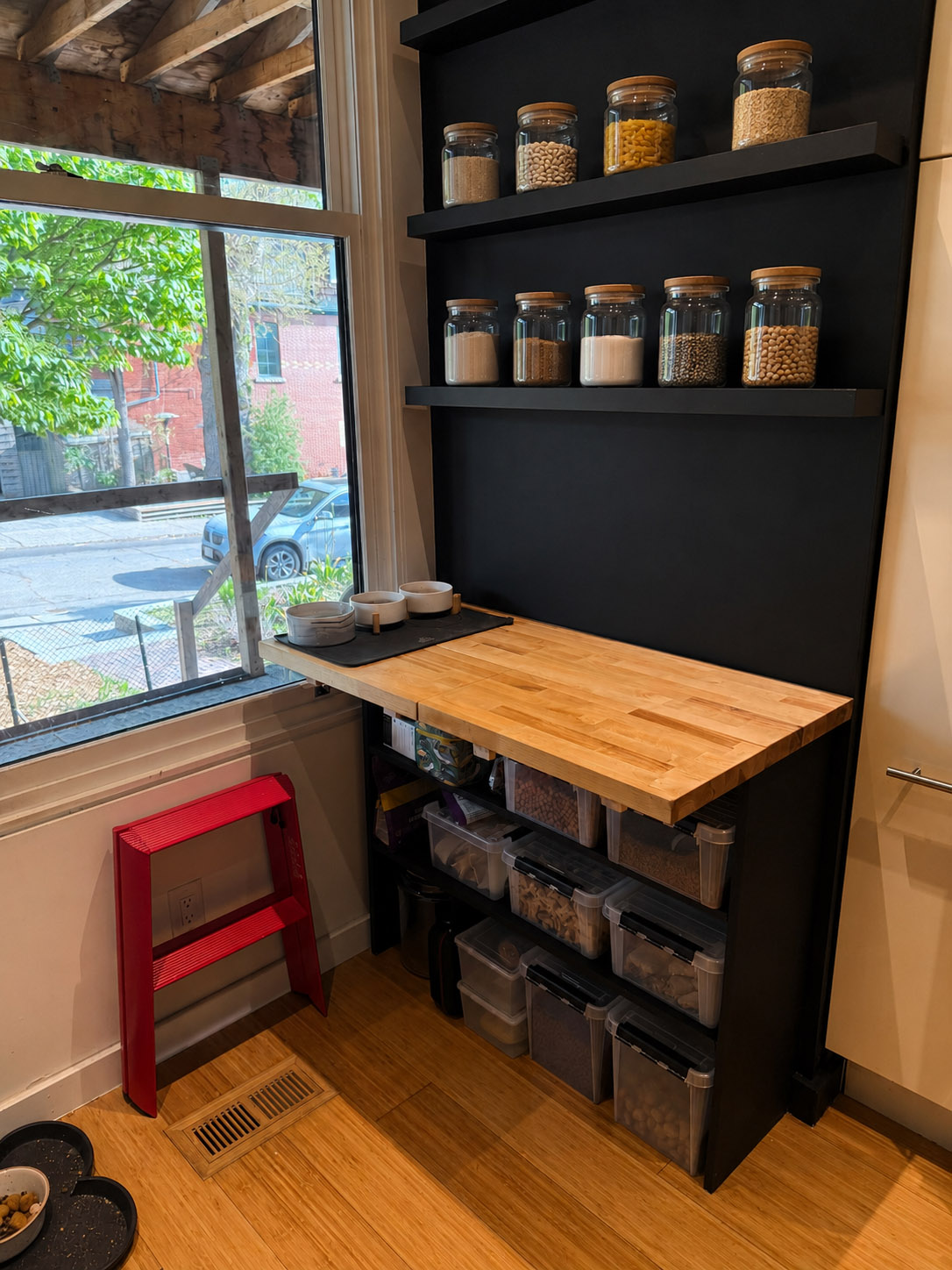 Custom pantry workstation with butcher block countertop and floating shelves