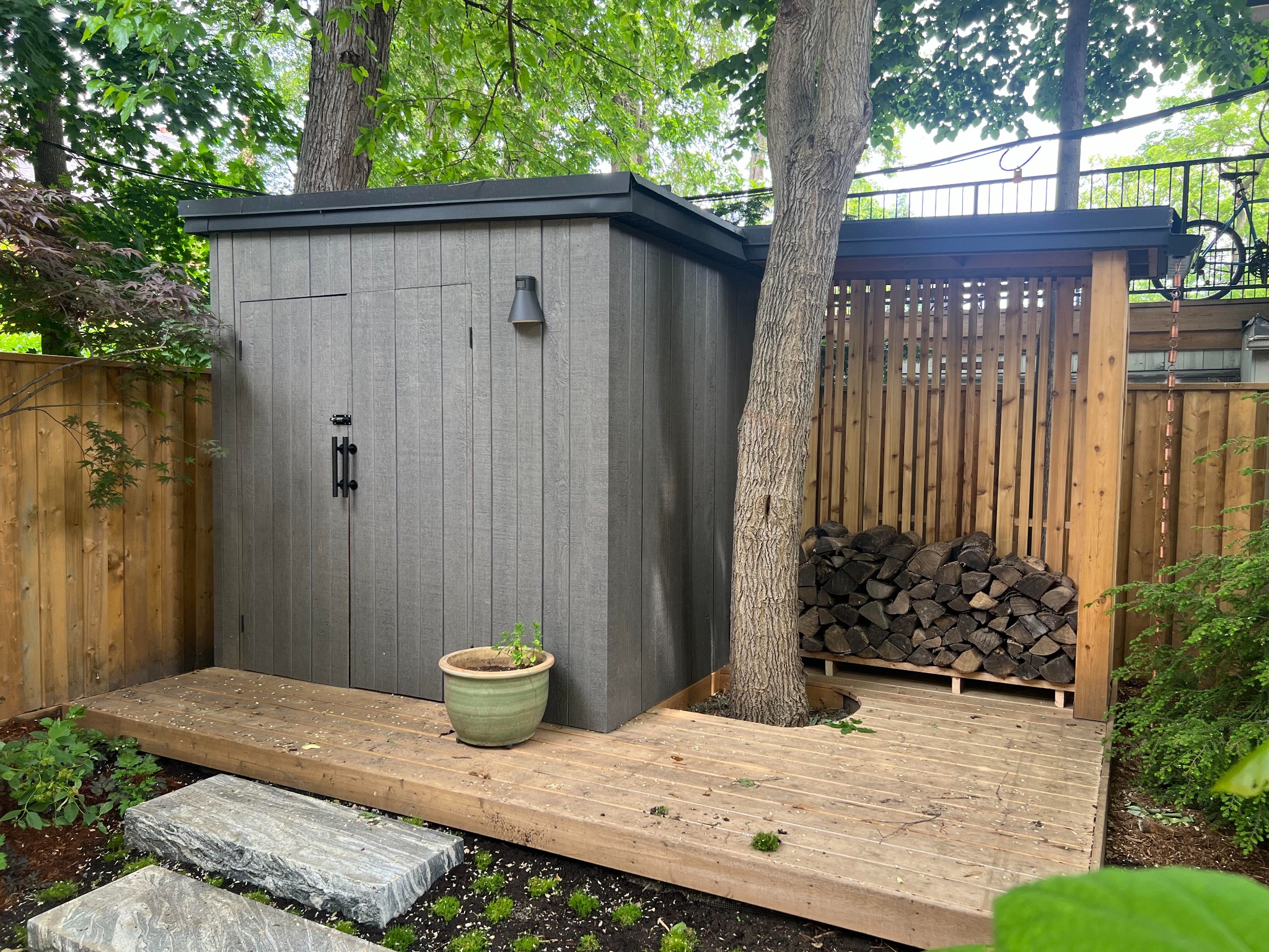 Custom modern garden storage building with integrated firewood shelter