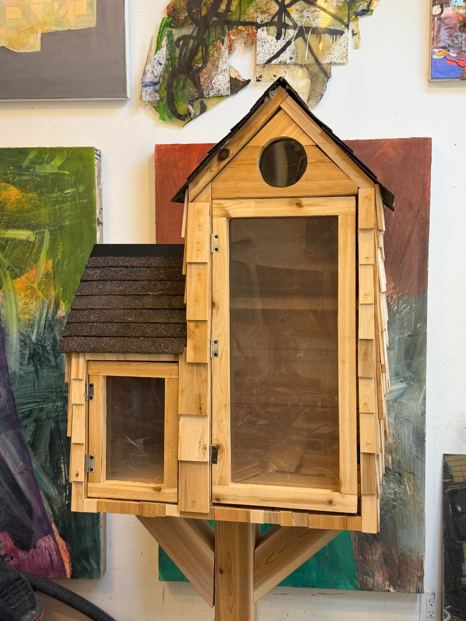 Straight-on workshop view of the Little Library doors and circular window